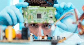 Image of Man looking at computer circuit